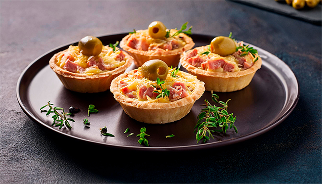 Mini quiche de mortadela italiana Marba superiore com pistache